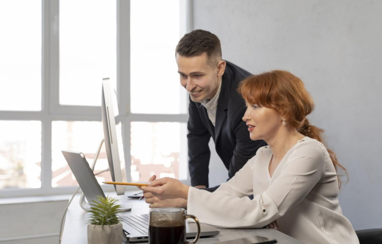 Professional analyzing rolling budget charts and financial forecasts on laptop with graphs and planning documents